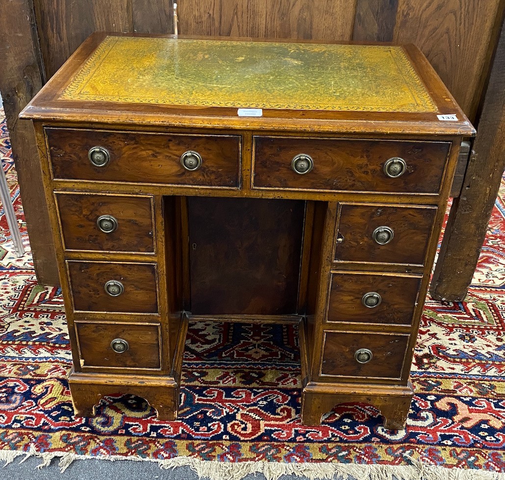 A reproduction 18th century style yew kneehole desk, length 76cm, depth 50cm, height 75cm